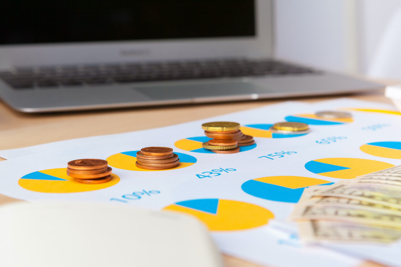 Total asset visibility portrayed in the concept of stack coins and graph charts.
