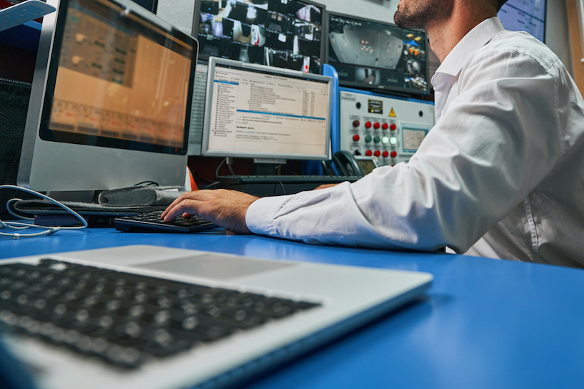 Security monitoring workstation reviewing camera feeds for site safety analytics